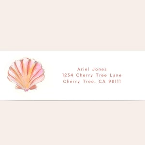 May include: A pink and orange seashell with a white background. The text "Ariel Jones, 1234 Cherry Tree Lane, Cherry Tree, CA 98111" is printed below the seashell.