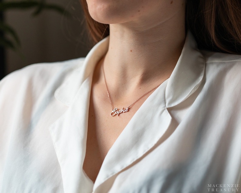 May include: A delicate gold necklace with a cursive name pendant that reads "Sophie".