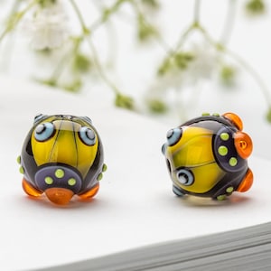 Glass Bead Pair for Jewelry, Yellow, Purple  Lampwork Beads with Orange Burbles and Light Green Dots