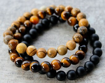 Juego de 3 pulseras para hombre: ojo de tigre dorado, jaspe arena y ónix negro o piedra de lava a elegir.