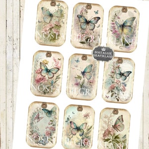 May include: Nine vintage-style printable tags featuring butterflies and floral designs. Each tag has a distressed, aged look with a light brown background and a white border. The butterflies are blue and white with delicate wings. The flowers are pink, white, and yellow. The text "Nostalgie Grafikland" appears on some of the tags.