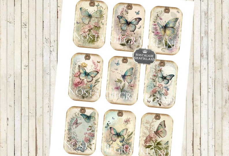 May include: Nine vintage-style printable tags featuring butterflies and floral designs. Each tag has a distressed, aged look with a light brown background and a white border. The butterflies are blue and white with delicate wings. The flowers are pink, white, and yellow. The text "Nostalgie Grafikland" appears on some of the tags.