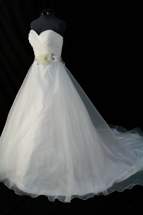 Wedding dress cream color with wedding sash.