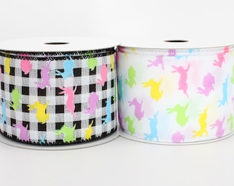 May include: Two rolls of Easter ribbon featuring a bunny silhouette design. One roll is black and white gingham with colourful bunnies. The other roll is white with pastel coloured bunnies.