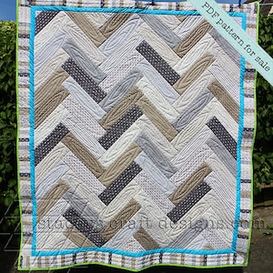 Op de afbeelding: Een quilt met een chevron-patroon in grijstinten, bruin en wit. De quilt is gestikt met een houtnerf-ontwerp. De quilt is afgewerkt met een turquoise en groene rand. De tekst "PDF pattern for sale" is zichtbaar in de rechterbovenhoek van de afbeelding.