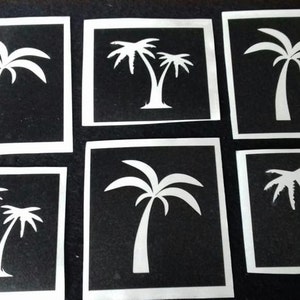 Puede incluir: Seis plantillas de palmeras en blanco y negro, cada una en un marco cuadrado. Las plantillas son para manualidades y decoración.