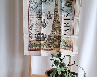 May include: A white tea towel with a vintage Parisian design featuring the Eiffel Tower, a crown, and the text "Paris Menu" in a decorative font.