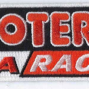May include: A rectangular embroidered patch featuring the word HOOTERS in bold red letters on a black background, positioned above the text IHRA RACING in white and red letters on a white background, with a registered trademark symbol included.