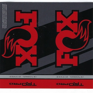 May include: A rectangular decal featuring the red Fox logo and text on a black and dark gray background. The design includes the text "INTERNAL BYPASS" and "TRD PRO" in black and white. A warning label is printed in the top left corner.