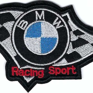 May include: Black and white checkered flag with a blue and white BMW logo in the center. The text "Racing Sport" is embroidered in red below the logo.
