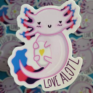 May include: A pink axolotl sticker with a blue, red, and black swirl design. The axolotl is smiling and has a small yellow heart on its belly. The text "LOVE AXOLOTL" is written on the sticker.