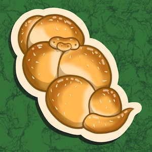May include: An illustration of a loaf of bread, featuring a golden-brown color with sesame seeds sprinkled on top. The bread is stylized with a white border, set against a green background.