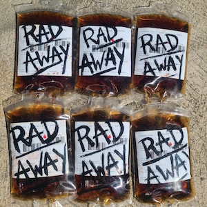 Six Fallout RadAway prop bags displayed in two rows of three on cement, cosplay and display prop packs.