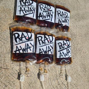 Six Fallout RadAway prop bags displayed in two rows of three on cement, cosplay and display prop packs.