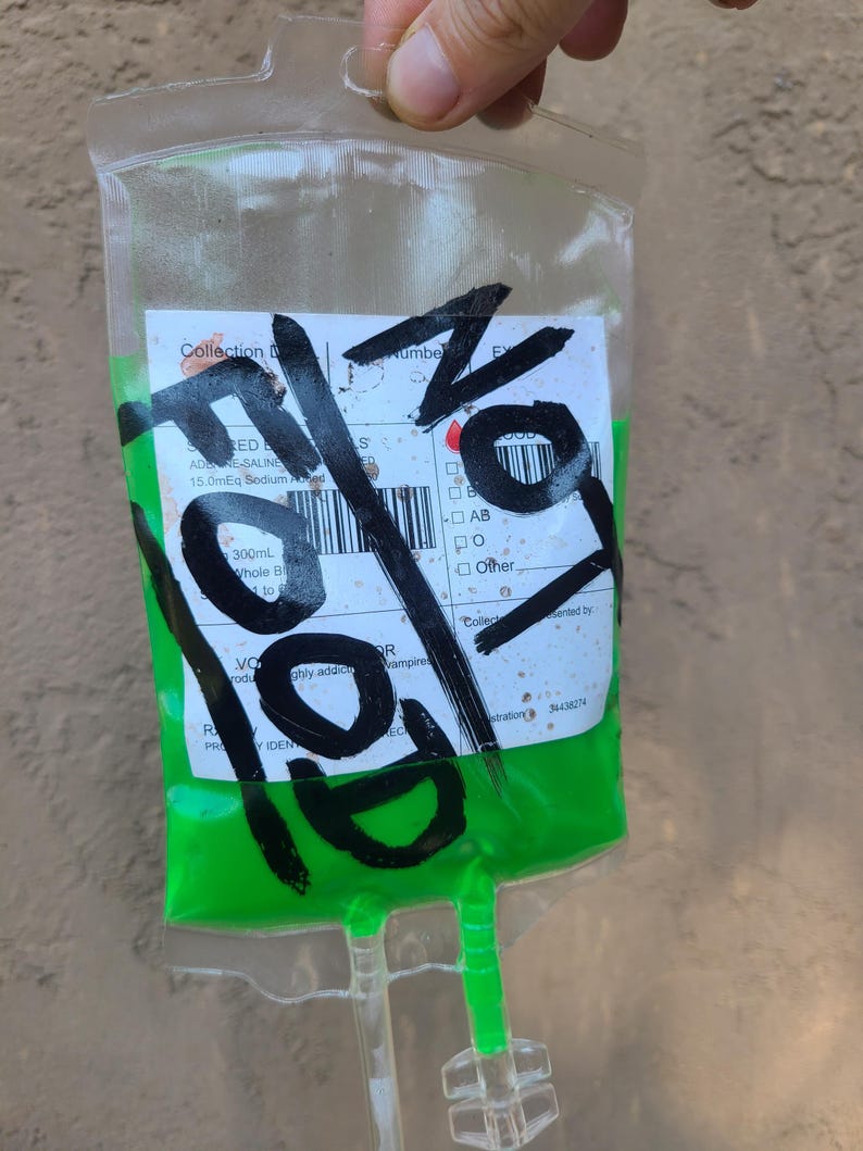 A Fallout prop Irradiated Blood pack showing the weathered version of a label. The label says "Not Food".
