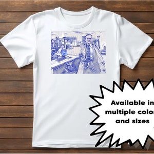 May include: White t-shirt with a blue and white image of a man in a suit and tie standing in an office. The text "Available in multiple colors and sizes" is on a white starburst.