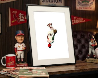 Puede incluir: Una impresión artística enmarcada que presenta una ilustración minimalista de un jugador de béisbol con un uniforme blanco con el número 1 y detalles en rojo, representado en posición invertida sobre un fondo blanco liso en un marco negro.