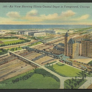 May include: An aerial view of the Illinois Central Depot in Chicago, with train tracks and surrounding buildings in the foreground. The depot is a large, multi-story building with a prominent tower. The image is a vintage postcard with the text "180 - Air View Showing Illinois Central Depot in Foreground, Chicago" at the top.