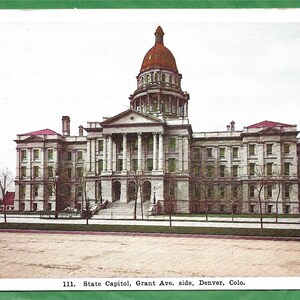 May include: A vintage postcard depicting the Colorado State Capitol building in Denver, Colorado. The building is a large, white structure with a dome and columns. The postcard is printed with the text "The Thayer Publishing Co., Denver." and "111. State Capitol, Grant Ave. side, Denver, Colo."
