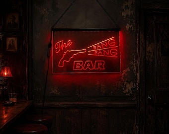 May include: A rectangular neon sign with a black frame and a hanging chain, displaying bright red neon text that reads The BANG BANG BAR, accompanied by a graphic outline of a handgun pointing toward the text, all glowing against a dark wall.