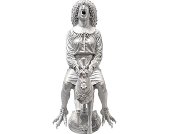 May include: A monochromatic silver-toned figurine depicting a figure with a large curly wig and an open-mouthed expression, wearing a long-sleeved blouse and skirt, mounted on a small horse with clawed feet resting on a circular base.