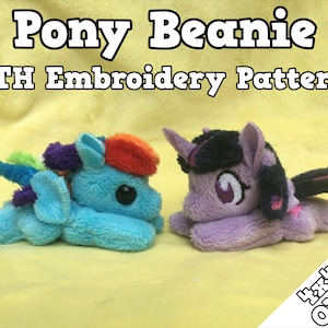 May include: A digital embroidery pattern for making a plush pony beanie. The pattern features two ponies, one blue and one purple, with rainbow-colored manes and tails. The text "Pony Beanie ITH Embroidery Pattern" is at the top of the image.