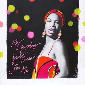 May include: A black and white portrait of a woman wearing a colorful head scarf and dress. The background is black with pink and green circles. The text "My Baby just cares for Me" is written in pink cursive.