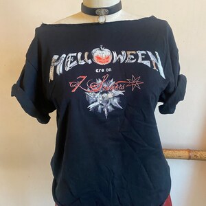 May include: Black t-shirt with a white graphic of the band "Helloween" with a pumpkin and the text "are on 7 Sinners".