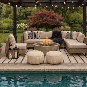 May include: Outdoor living space featuring a sectional sofa, fire pit, and two woven ottomans. The seating area is under a pergola with string lights, with potted plants and a pool in the foreground.