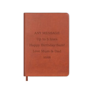 May include: A brown leather-bound journal with a personalised message that reads "ANY MESSAGE Up to 5 lines Happy Birthday Sam! Love Mum & Dad XXXX".
