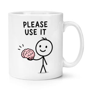 May include: A white ceramic mug featuring a black line drawing of a stick figure holding a pink brain. Above the figure, the text reads "PLEASE USE IT" in bold black capital letters. The mug has a standard handle and a smooth, glossy finish.