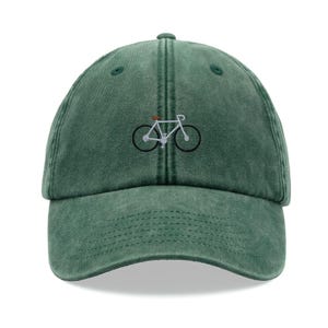 Puede incluir: Una gorra de béisbol de estilo vintage verde con un diseño de bicicleta blanca bordada.