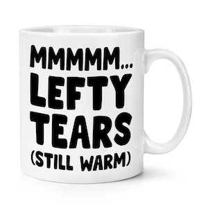 May include: White ceramic mug with black text that reads "MMMM... Lefty Tears (Still Warm)"