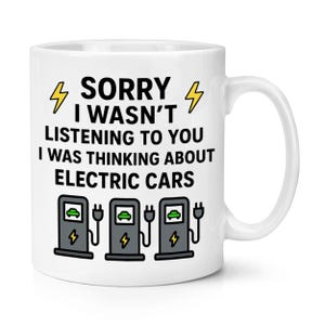May include: White ceramic mug featuring the text "SORRY I WASN'T LISTENING TO YOU I WAS THINKING ABOUT ELECTRIC CARS" and images of electric car charging points. The design includes yellow lightning bolt graphics.