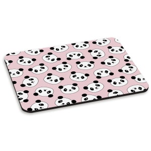 May include: A pink mouse mat with a repeating pattern of black and white panda faces.
