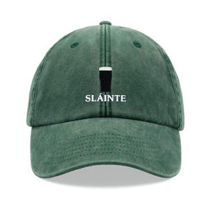 May include: A green baseball cap with a white embroidered pint glass and the word "Sláinte" on the front.