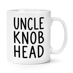 May include: A white ceramic mug featuring the black text UNCLE KNOB HEAD printed in a bold, sans-serif font on the front. The mug has a smooth, glossy finish, a cylindrical body, and a curved handle on the right side for holding the vessel.