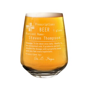 May include: A clear glass beer mug with a humorous prescription label that reads "Prescription: BEER 1 glass Patient Name: Steven Thompson Dosage: To be taken once daily. Ideally to be consumed cold. If problems persist, double the dosage until symptoms ease and you feel more hoptimistic. Prescribed by: Dr B. Hops"
