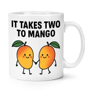 May include: White ceramic mug featuring the phrase "IT TAKES TWO TO MANGO" in black text. The mug showcases two cartoon mangoes holding hands, each with a smiling face, orange body, green leaf, and small black legs. A fun, fruit-themed design.