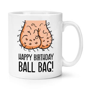 May include: White ceramic mug with a humorous illustration of a scrotum and the text "HAPPY BIRTHDAY BALL BAG!" in black. The mug has a curved handle and is suitable for hot or cold beverages.