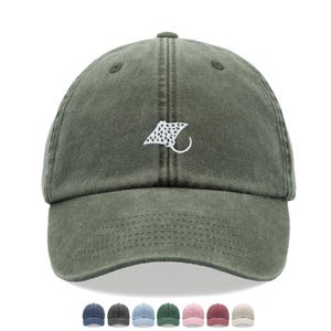 May include: Olive green baseball cap with a white stingray design embroidered on the front. The cap has a curved peak and an adjustable strap. A row of coloured caps are shown below the main cap.