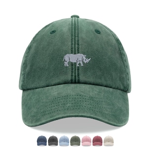 May include: A green baseball cap with a curved peak and adjustable strap. The cap has a light grey embroidered rhinoceros design. Several other cap colours are shown below the main cap.