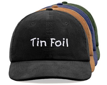 May include: A black corduroy baseball cap with white embroidery that reads "Tin Foil".