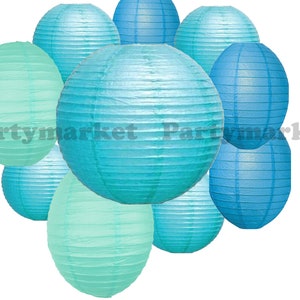 May include: A collection of paper lanterns in various shades of blue and teal. The lanterns are round and oval, with a ribbed texture. The image includes the text "Partymarket".