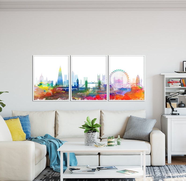 May include: A set of three watercolor paintings depicting the London skyline. The paintings are framed in white and feature iconic landmarks like the London Eye, Big Ben, and the Shard.