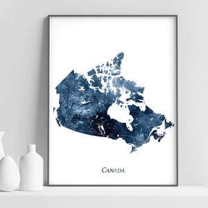 May include: A watercolour print of a map of Canada in shades of blue. The map is outlined in white and the word "CANADA" is printed in white at the bottom of the print.