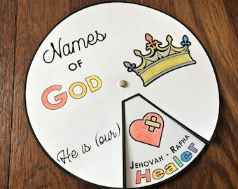 May include: A white, circular educational toy with the words "Names of God" and "He is (our)". It features a crown, a heart with a bandage, and the words "Jehovah - Rapha Healer".
