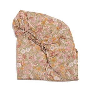 May include: A green and pink floral print fabric with a gathered ruffle detail.