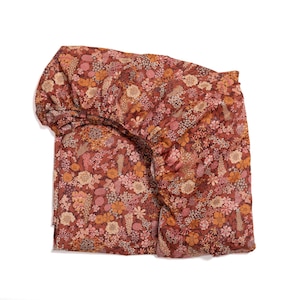 May include: A fitted sheet with a floral pattern in shades of pink, orange, and brown. The sheet is made of a soft, comfortable fabric and is perfect for adding a touch of color and style to any bedroom.