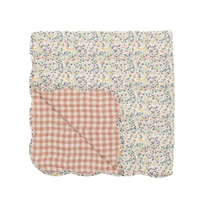 May include: A reversible quilt with a floral pattern on one side and a gingham pattern on the other. The floral side features small, colorful flowers on a cream background. The gingham side is a reddish-brown and white check.